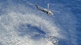 A U.S. Air Force HH-60G Pavehawk helicopter from the 55th Rescue Squadron hovers 600 nautical miles off the Pacific Coast of Mexico to hoist two badly burned Chinese fishermen, on May 5, 2014.