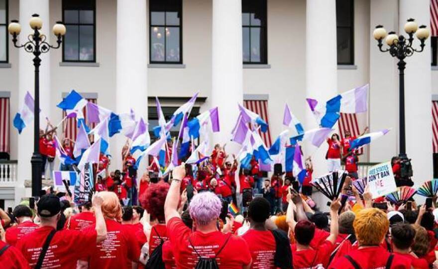 Advocates outside Florida's historic Capitol wave drag pride flags during the Drag Queens March in 2023.