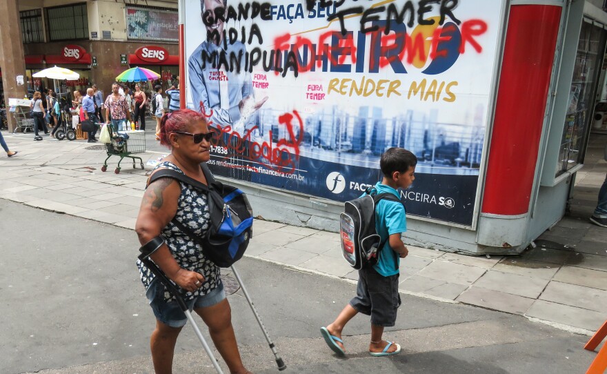 In downtown Porto Alegre, graffiti calls for the ouster of President Michel Temer.