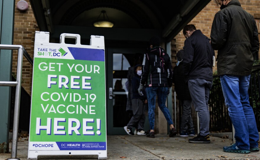 People line up outside of a free COVID-19 vaccination site that opened in Washington, DC in December.