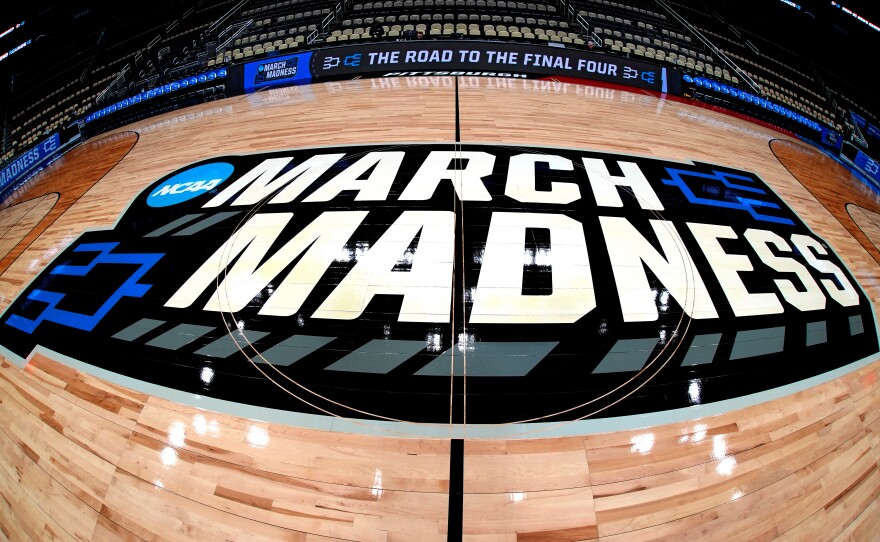 FILE - March Madness logo sis displayed at center court during the opening rounds of the NCAA college basketball tournament in Pittsburgh, Wednesday, March 20, 2024.