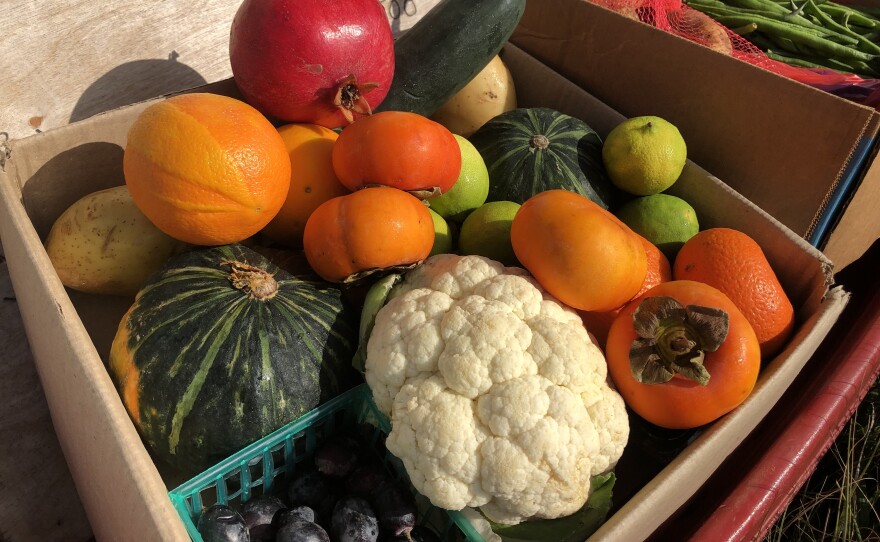 Fruits and vegetables are stacked inside of carboard boxes on a red wagon, Dec. 6, 2021.