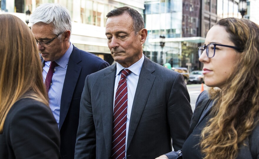 Douglas Hodge, shown last October outside the federal courthouse in Boston, has been sentenced to nine months in prison.