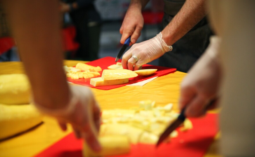 Chefs from José Andrés' ThinkFoodGroup chop squash that will go into a giant paella.