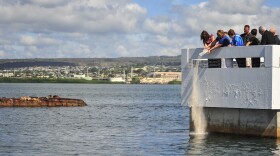 The family of Pearl Harbor survivor Coxswain Gale Mohlenbrink commits his ashes to the sea near the USS Utah Memorial on Ford Island.