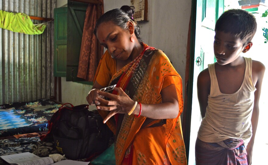 A community health worker conducts a home visit in 2013 with an expectant mother in Sylhet, Bangladesh, to screen for infections that have been linked to premature birth.