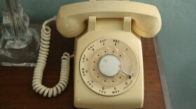 The dial phone that rings like a school bell next to the author's bed 