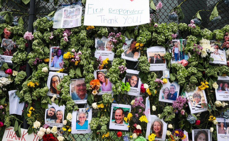 Family members hold vigil last month for the deceased victims and people who are missing from the condo collapse in Surfside, Fla.