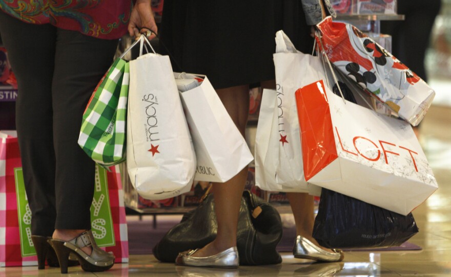 Shoppers look at a display at the Dadeland Mall in Miami on Nov. 25. Princeton professor Sheldon Garon says Americans spend too much and save too little compared to Europeans and Asians.