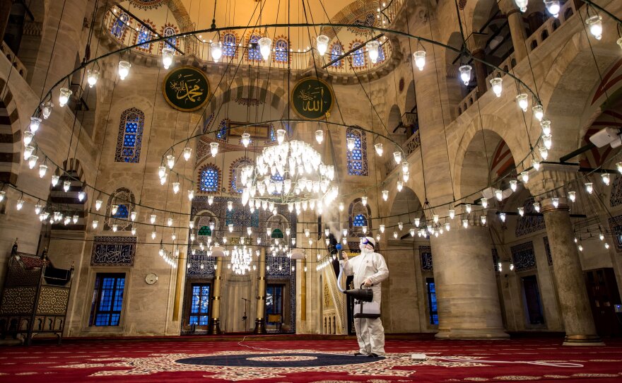 A government worker disinfects the Kılıç Ali Pasa mosque in Istanbul last week. Turkey is just one of a host of countries across the Muslim world where Friday prayers have been banned or curtailed to stem the spread of the coronavirus.