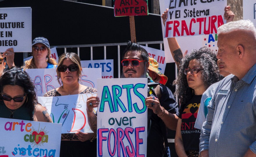 Protesters opposed to San Diego Mayor Todd Gloria's budget cuts to arts programs gather at San Diego's Civic Center Plaza before a City Council meeting on April 20, 2026.