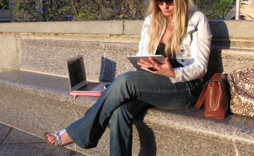 Leslie Bradshaw displays her iPad and MacBook Air -- some of the wireless devices she carries with her. Bradshaw -- who doesn't have a land line, high-speed Internet or subscription TV at home -- describes herself as a "digital gypsy."