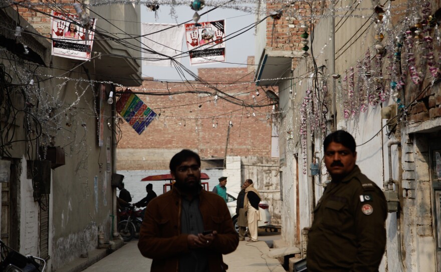 The posters with Zainab's photo and calls for justice are strung outside her home in an alleyway in Kasur.