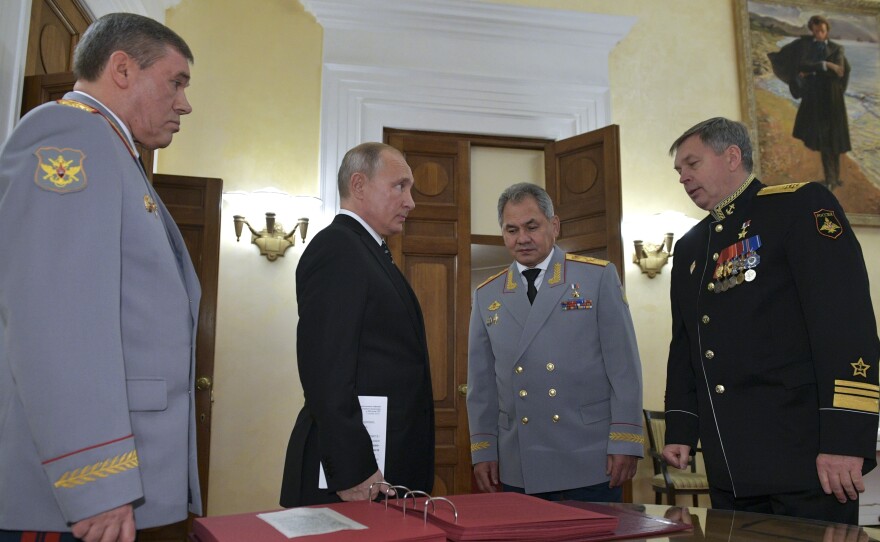 Russian President Vladimir Putin (second from left) meets military officials, including Igor Kostyukov (far right), the deputy chief of military intelligence for the GRU. The 2018 event in Moscow marked the centenary of the GRU, which has been involved in many major operations in recent years. U.S. intelligence suspects the GRU of involvement in a reported bounty program in Afghanistan.