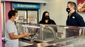 Tocumbo Ice Cream owner Omar Ramirez talks with Governor Gavin Newsom (right) and San Diego County Supervisor Nora Vargas (center), Feb. 8, 2021.