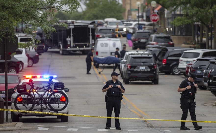 First responders take away victims from the scene of a mass shooting at a Fourth of July parade on July 4, 2022 in Highland Park, Illinois.