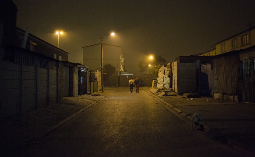 Two men on an evening walk. The total area of Manenberg is 1.29 square miles. 2016.