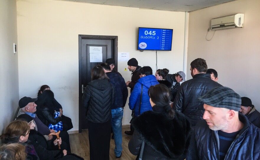 People crowd the waiting room at the Zugdidi regional office of the Ministry of Internally Displaced Persons.