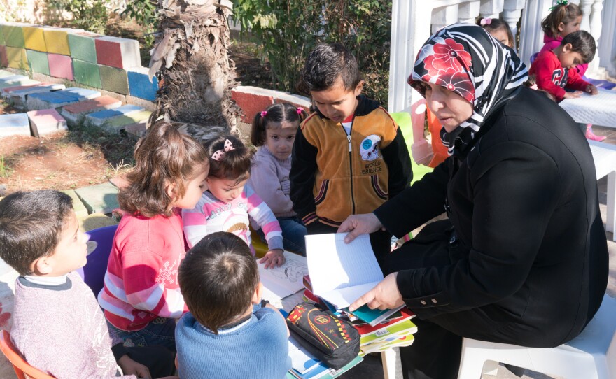 A teacher works with children at the Bayti Orphanage in Reyhanli.