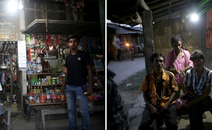 Before solar lighting, people in Rajat Jubilee stayed home after dark. There was nothing to do outside, and you might get bitten by a snake or attacked by a tiger. Now, when the sun goes down, the village comes to life. A store owner (left) is able to keep his shop open at night. A television (above) stays on for people to watch in the shop. Villagers (right) sit outside a restaurant.