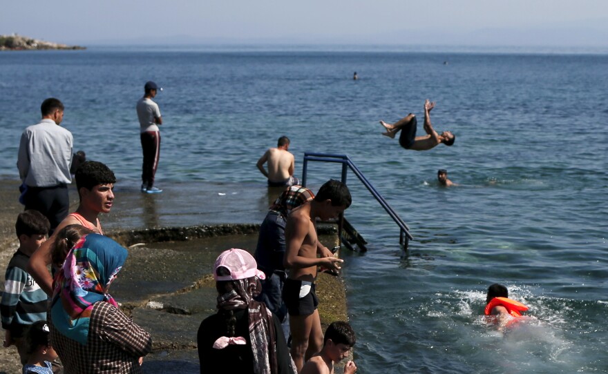 Refugees and migrants on the Greek island of Lesbos enjoy the sea.