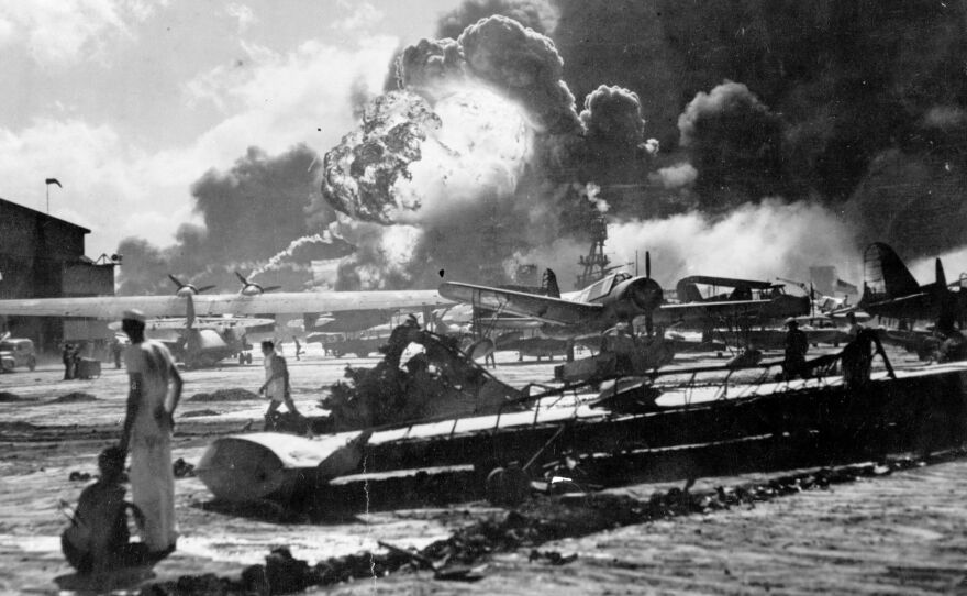 An explosion at the Naval Air Station Ford Island, Pearl Harbor, is seen during the Japanese attack. The U.S. is marking the 75th anniversary of the violence that thrust the country into World War II.