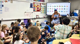 Shelly Crickett (center) teaches her students how to play the ukelele, Hawaii's best-known musical instrument, in San Diego, Calif., September 8, 2023. 