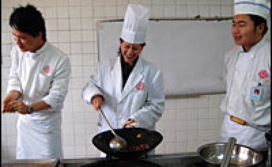 Melissa Block learns how to cook Kung Pao chicken at The Sichuan Higher Institute of Cuisine in Chengdu.