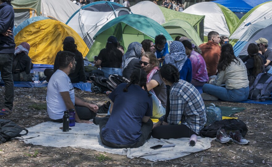 Protesters sitting around the tents at the "Gaza Solidarity" encampment on the UC San Diego campus, May 1, 2024.