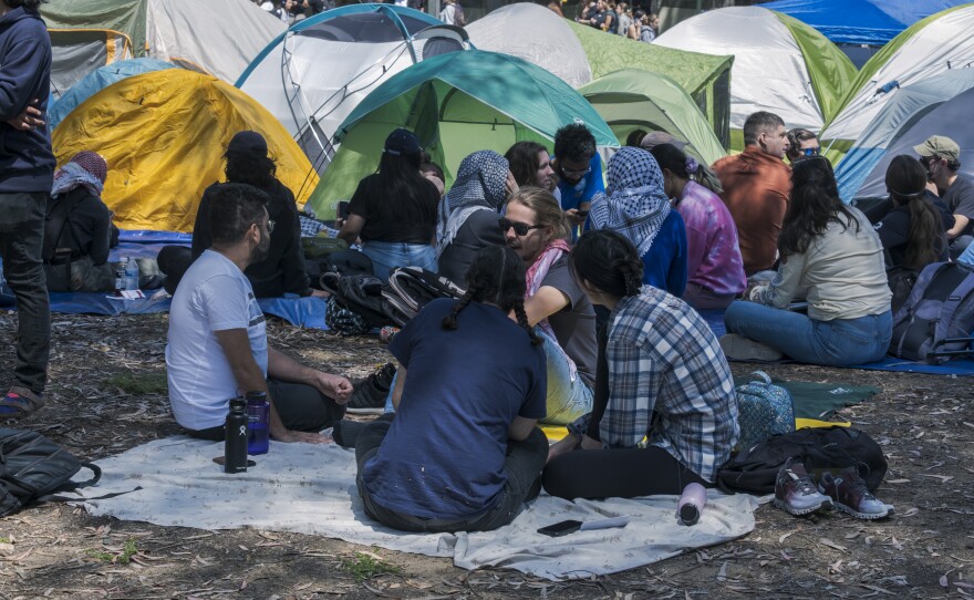 Protesters sitting around the tents at the "Gaza Solidarity" encampment on the UC San Diego campus, May 1, 2024.