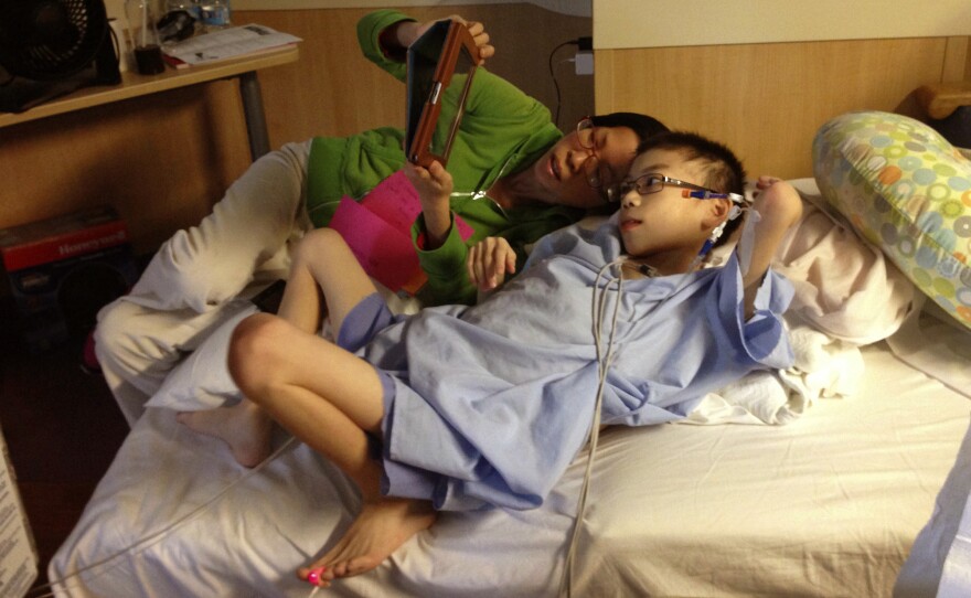 Kathy Liu and her son Joey Xu talk to friends back home in Gainesville, Fla., from his hospital room in Cincinnati.