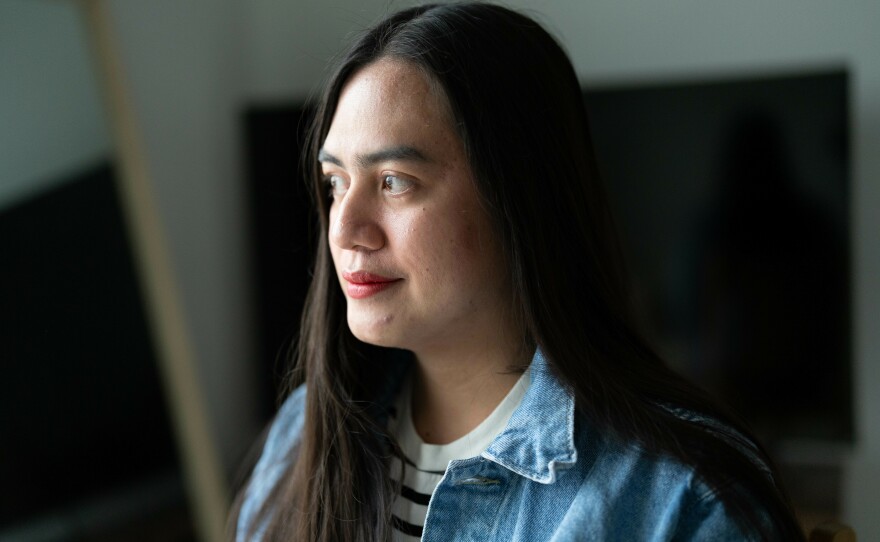 Roi Lubian poses for a portrait in her home in Bismarck, N.D. Originally from the Philippines, Lubian is working as a nurse in North Dakota. She says she moved to the United States in search of better economic opportunities.