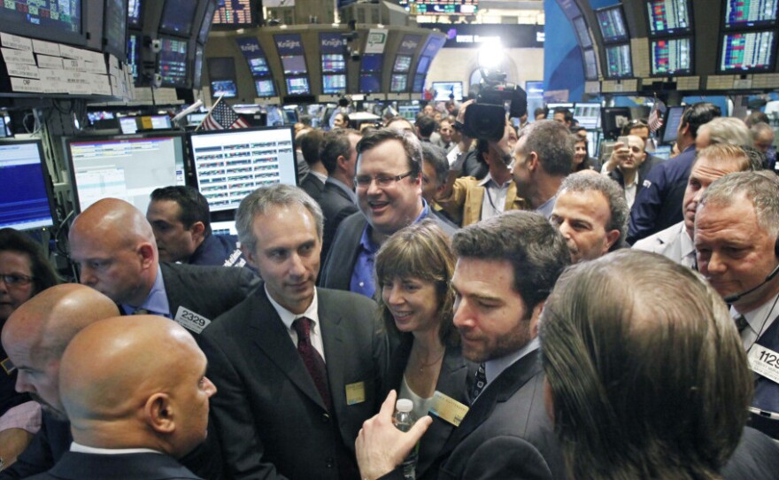 LinkedIn CEO Jeff Weiner, center right with beard, and Reid Hoffman, center background with glasses, listen to traders during their company's listing on May 19 on the New York Stock Exchange. The company reached a market value of $9 billion last week, leading to fears of another dot-com bubble.