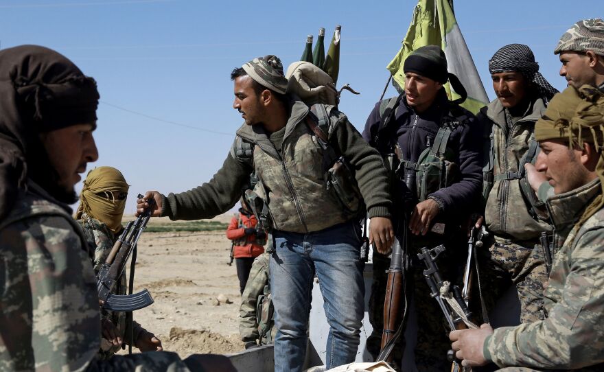 U.S.-backed Syrian Democratic Forces, made up of an alliance of Arab and Kurdish fighters, regroup on the northern outskirts of Deir Ezzor as they advance to encircle the ISIS bastion of Raqqa on Feb. 21.