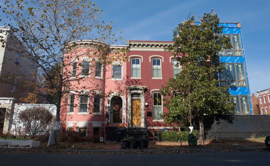 A newer home is undergoing renovations at the end of a block of row houses in the Shaw neighborhood of Washington, D.C. Newcomers began arriving in the neighborhood more than a decade ago.