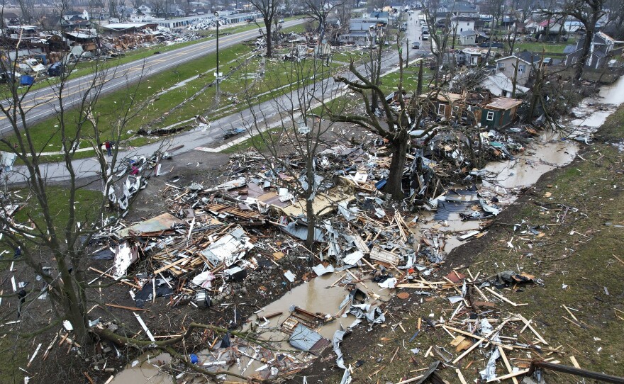 Debris scatters the ground on Friday near damaged homes following a severe storm in Lakeview, Ohio.