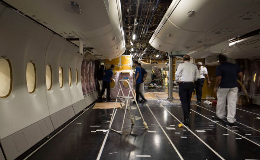 Maintenance workers strip down and inspect an Airbus A380, the largest passenger jet in the world.