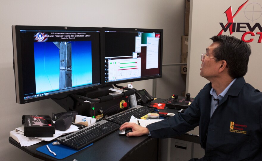 Doug Lee, electrical engineer at the National Product Testing and Evaluation Center, shows a CT scan of a damaged battery pack from a "hoverboard" scooter.