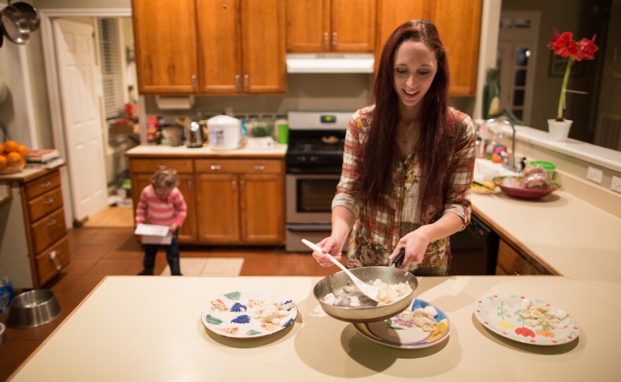 Maggie Barcellano prepares dinner in January 2014 at her father's house in Austin, Texas. Barcellano, who lives with her father, enrolled in the food stamps program while she works as a home health aide and raises her 3-year-old daughter. A study suggests that social safety nets, including food stamps, helped cushion income losses for middle- and working-class Americans during the recession.