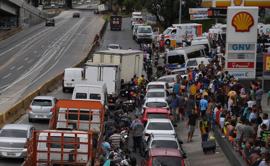Long, crowded lines extend from a gas station Monday in Rio de Janeiro. For more than a week, a massive truckers' strike has paralyzed fuel and food deliveries across Brazil.