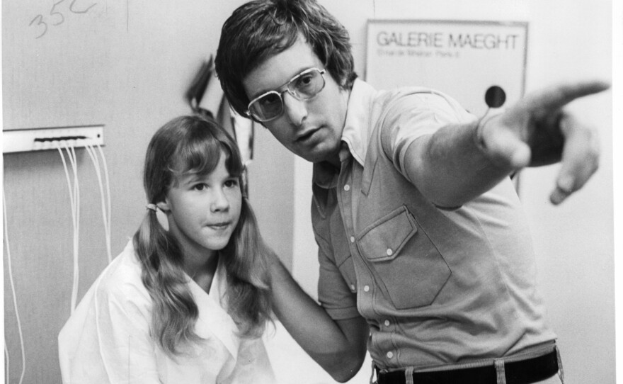 Friedkin gives direction to 12-year-old actress Linda Blair, who played the possessed Regan MacNeil, on the set of <em>The Exorcist</em>.