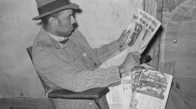 Ken Burns' new three-part documentary, <em>The U.S. and the Holocaust,</em> explores what everyday Americans knew — or didn't know — about what the Nazis were doing in Europe. Above, a tenant farmer reads a newspaper in Creek County, Okla., in February 1940.