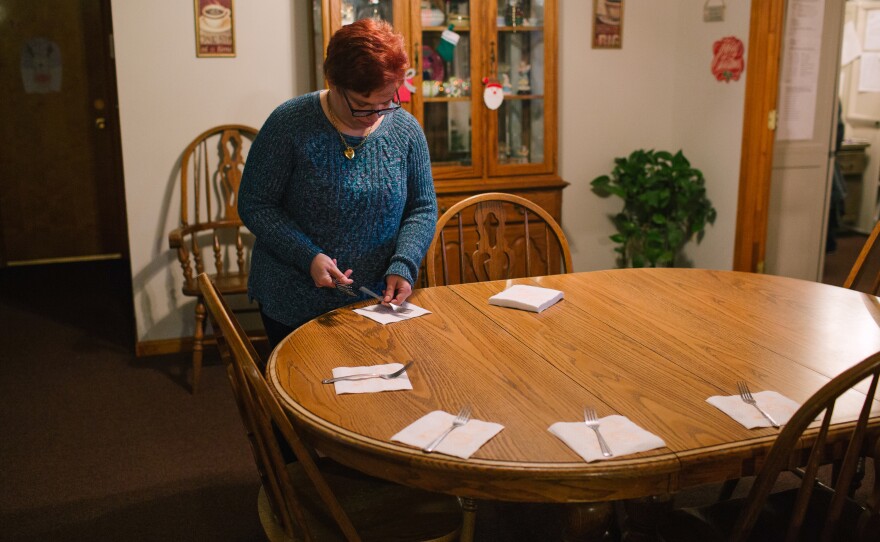 Pauline helps set the table for dinner at her group home. "I was scared the first day I went to the house," she says, referring to the group home she currently lives in. "I didn't know anyone." Since coming into the group home, Pauline says, she is happier.