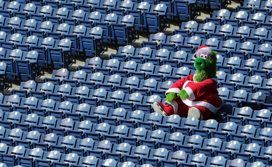 The Phillie Phanatic sits alone in the stands during a game between the Miami Marlins and the Philadelphia Phillies on Saturday. During this series, as many as 19 Marlins players and coaches had already been infected with the coronavirus.