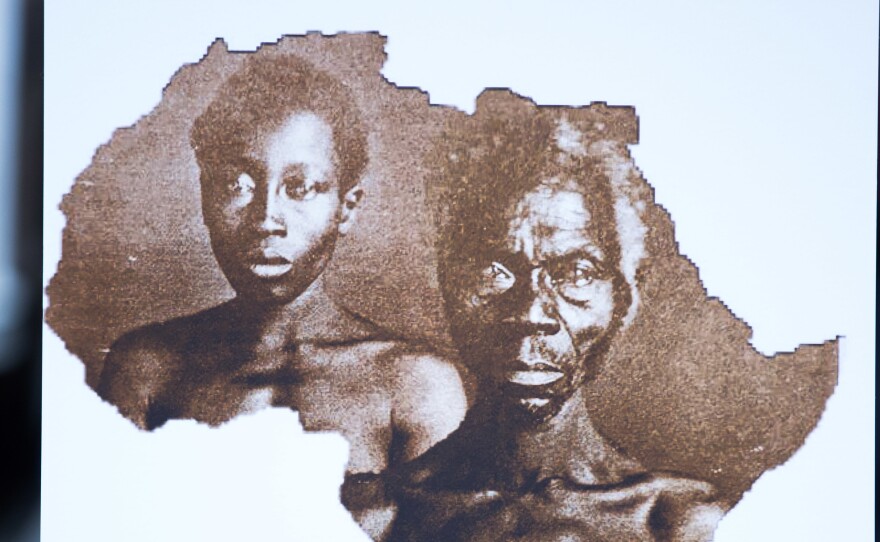 A sample image of "Papa" Renty and his daughter Delia, taken in 1850, are displayed during a press conference announcing a lawsuit against Harvard University on Wednesday in New York City.