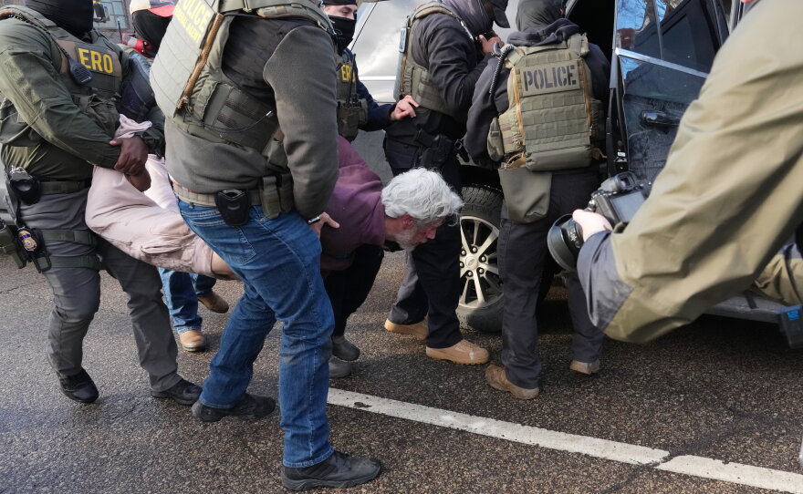 Protesters are arrested by federal agents near the scene where Renee Macklin Good was fatally shot by an ICE officer last January in Minneapolis.