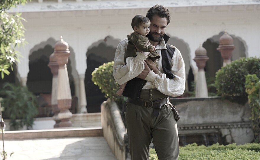 Tom Bateman as John Beecham with his baby.
