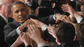President Barack Obama greets Congressional pages after delivering the State of the Union address.