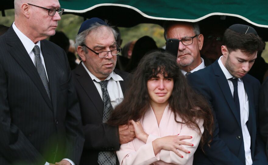 Family members attend the burial service for Lori Kaye, who was killed in the Chabad of Poway synagogue shooting on Saturday. The parents of the man accused in the shooting have condemned the attack as shocking and evil.