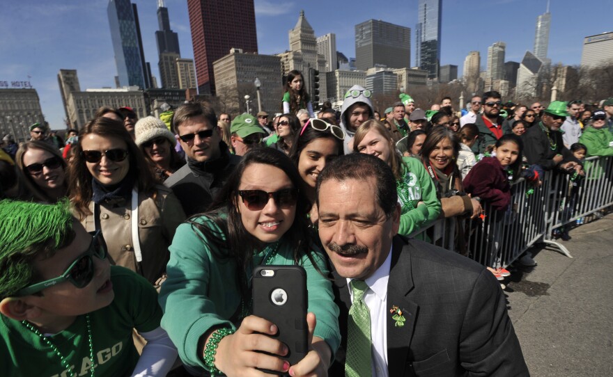 Samantha Hernandez, 17, poses for a selfie with Chicago mayoral candidate Jesus "Chuy" Garcia during the St. Patrick's Day parade in Chicago.